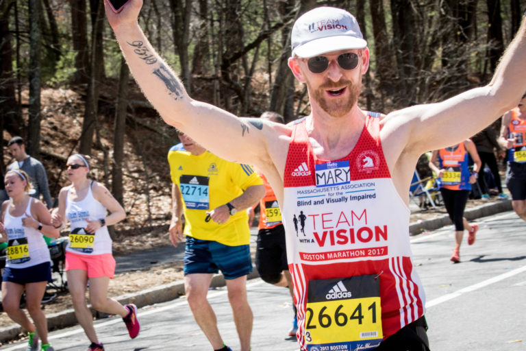 Marathon runner with his arms raised