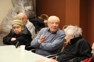 Group of seniors sitting at a table talking