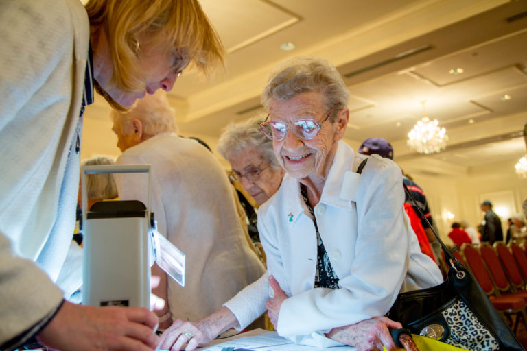 Two women at a table viewing a document