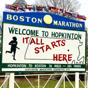 Sign at the start of the marathon "It all starts here" 