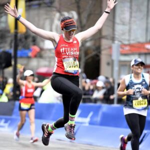Runner, Jesse Arnold leaping for joy at the finish line