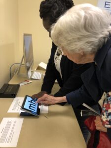 Older woman looking at a screen with enlarged type