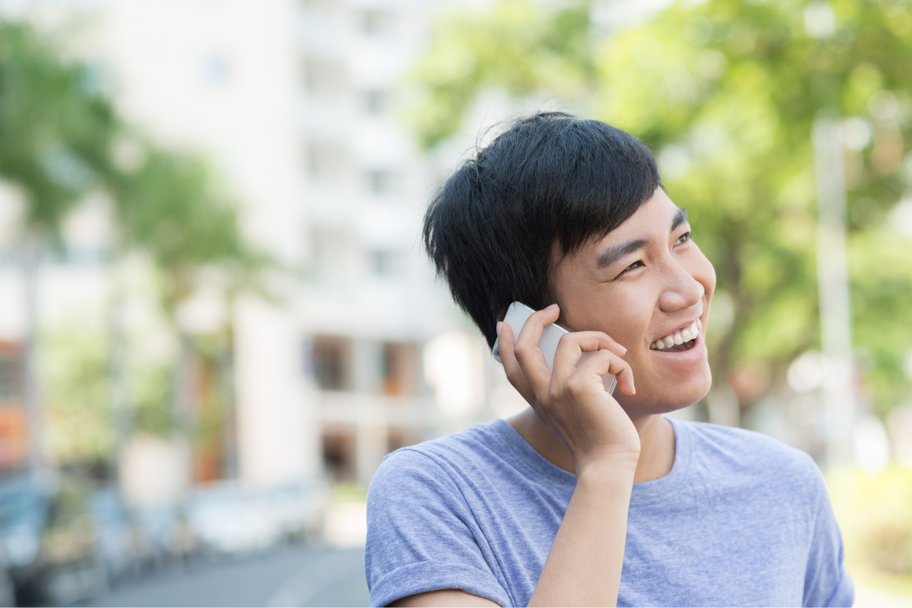 Person smiling and talking on the phone